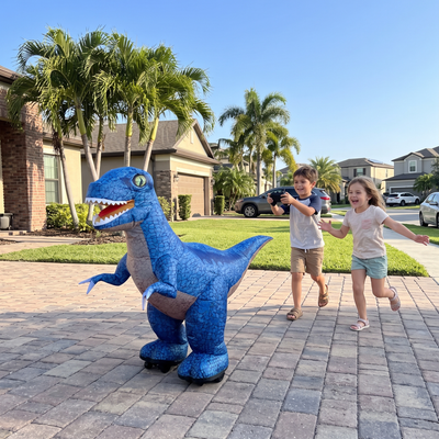 Blue DinoRush dino driving on a driveway with kids chasing it